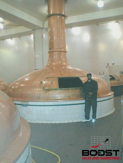 Paul Gage next to the Coors copper brewing kettle in golden Colorado 