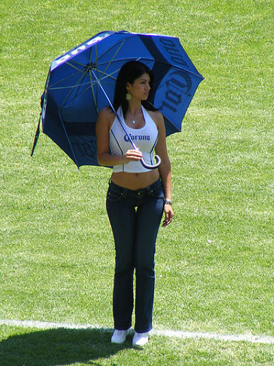 Aspiring Promotional model wearing tight jeans promoting corona beer at a football game