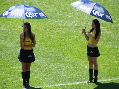 Sexy Corona Latina Beer Girls wearing short tight mini skirts up blouse with umbrellas during a promotional job